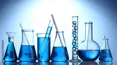 Test-tubes with blue liquid on blue background