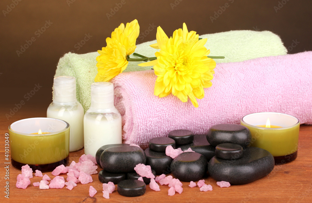 Spa setting on wooden table on brown background Spa setting on wooden table on brown background