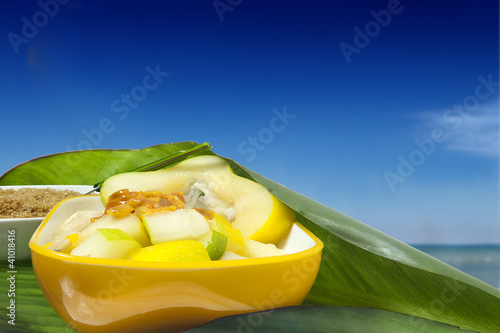 salad with tropical fruits along the tropical sea photo