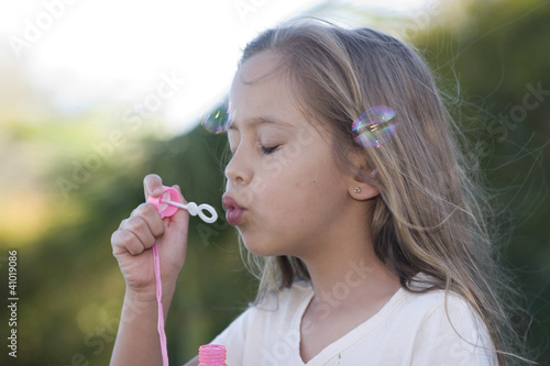 Beautiful Girl Blowing Bubbles