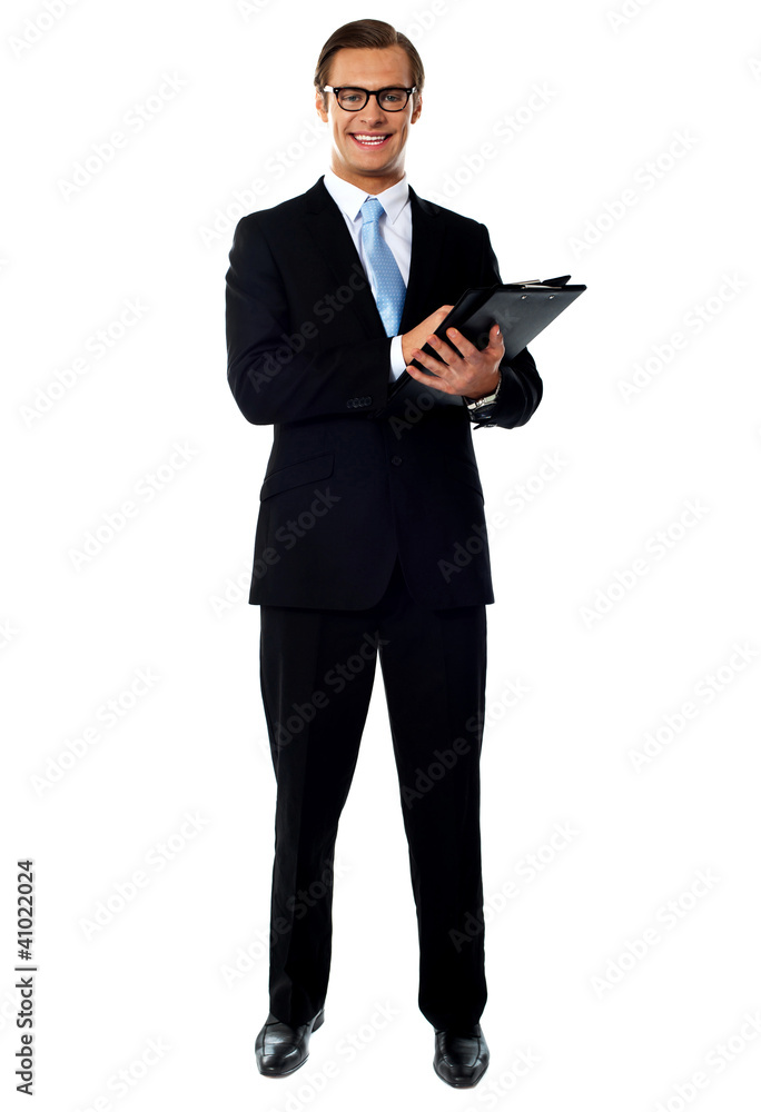 Full length view of relaxed businessman holding a folder Full length view of relaxed businessman holding a folder