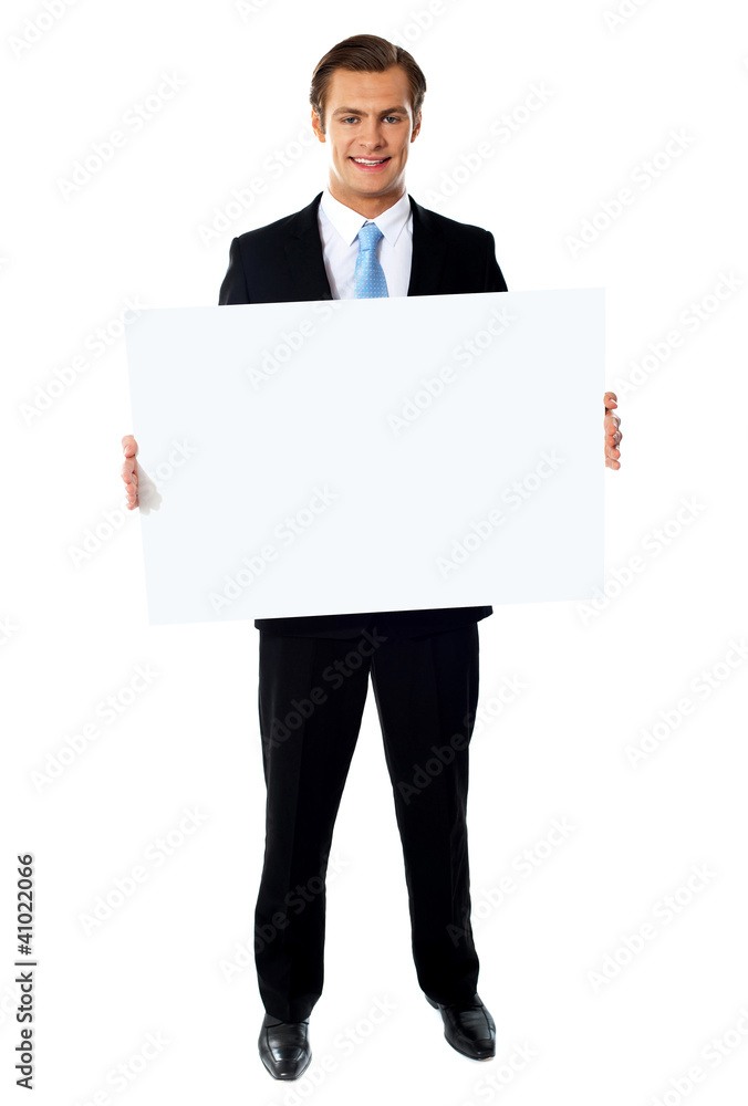 Portrait of businessman showing blank signboard Portrait of businessman showing blank signboard