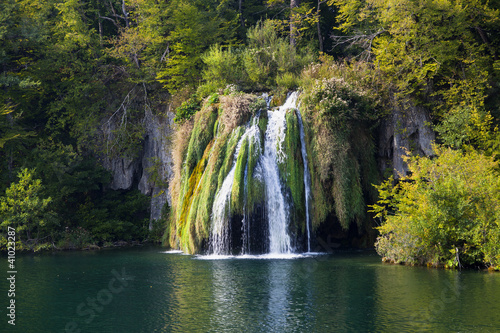 water cascades over moss and plants in plitvice  croatia