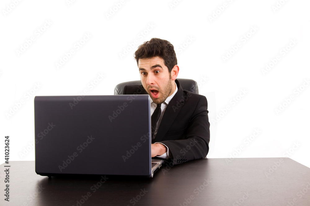 Young business man looking at screen computer with a excited exp Young business man looking at screen computer with a excited exp