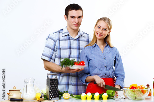 Husband and wife together coooking at home