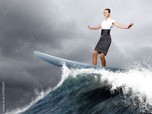 Photography Businesswoman surfing on the sea waves