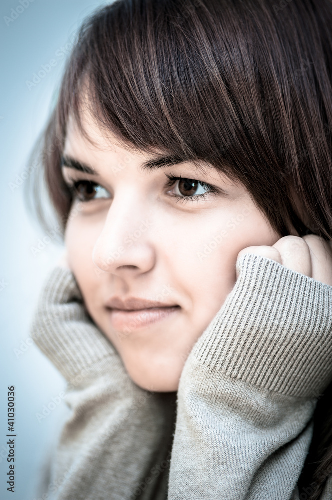 Portrait of confident young woman resting her chin on hands Portrait of confident young woman resting her chin on hands