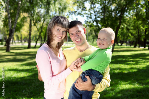Young family with a child in summer park