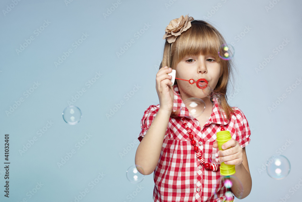 Portrait of little girl blowing soap bubbles Portrait of little girl blowing soap bubbles