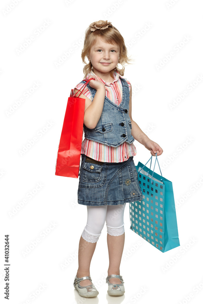 Full length of little girl with shopping bags over white Full length of little girl with shopping bags over white