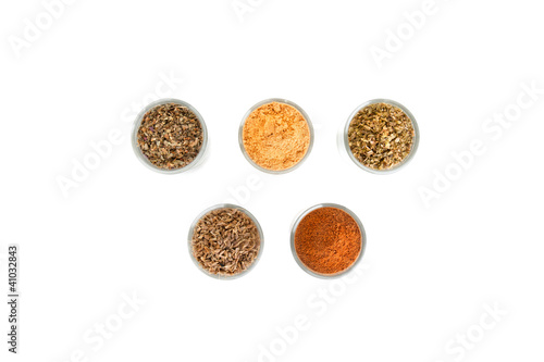 Spices and herbs in small glass bowls