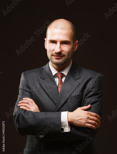 Portrait of a successful businessman on black