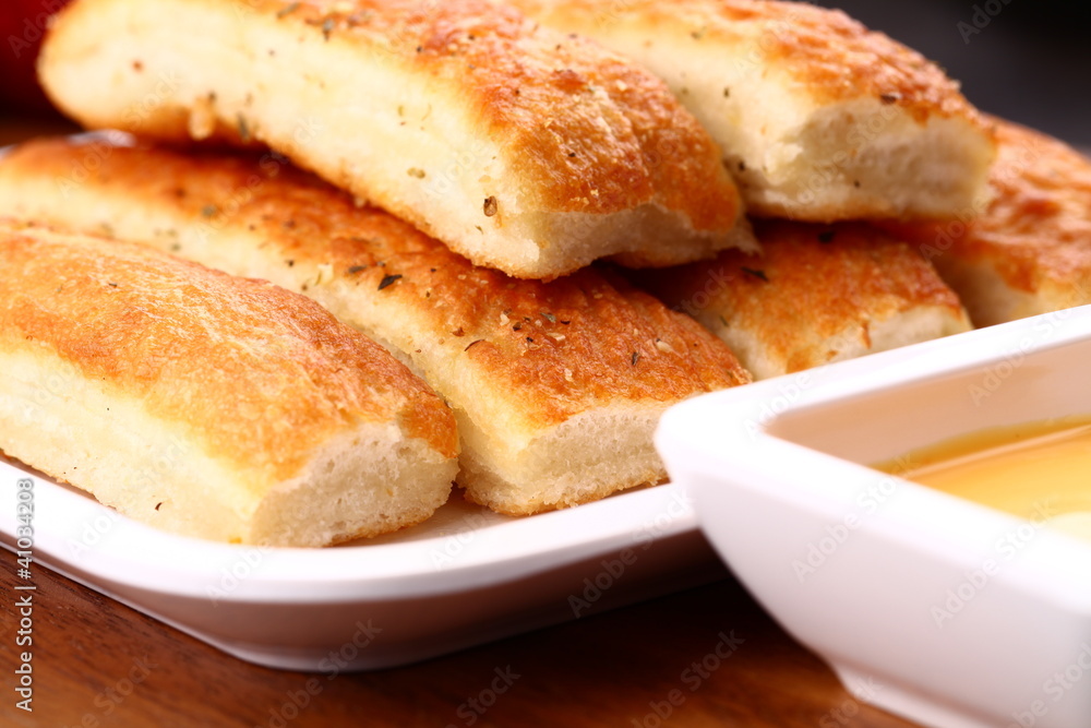 Fresh breadsticks served with dip sauce.