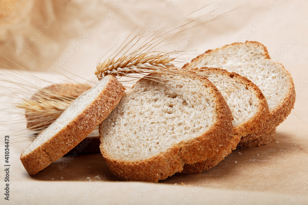Fresh bread isolated on a light brown background.