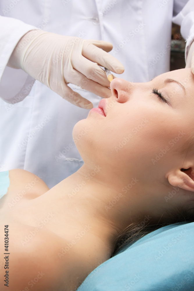 A young woman receiving an injection, closeup A young woman receiving an injection, closeup