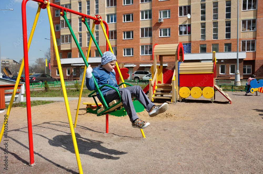 Fototapeta premium A boy on a swing