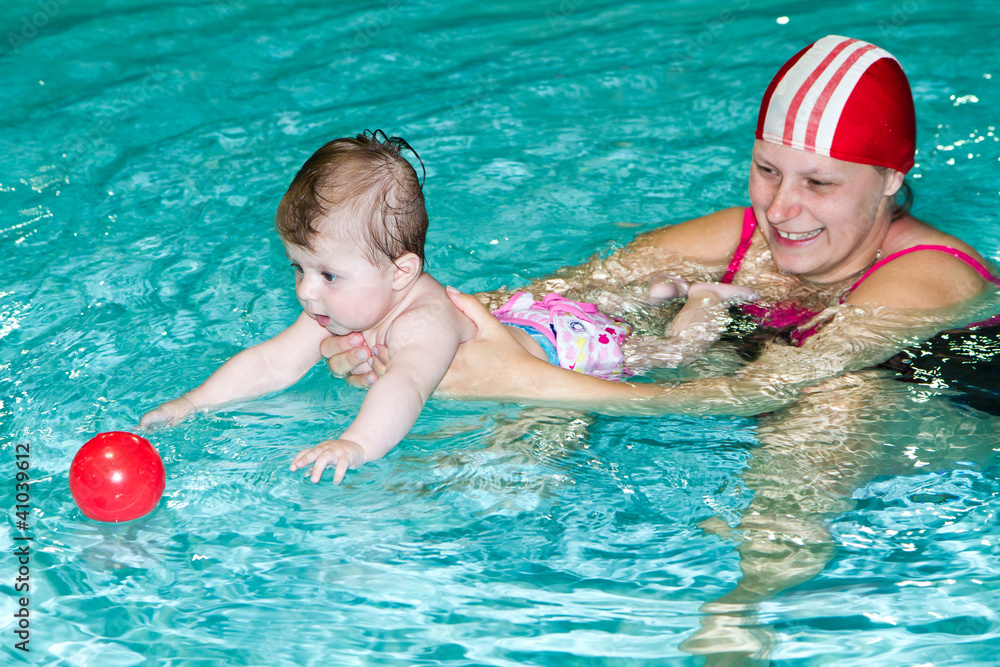 family with baby  in the swimming pool