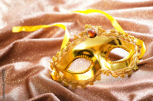 Golden mask on the satin background