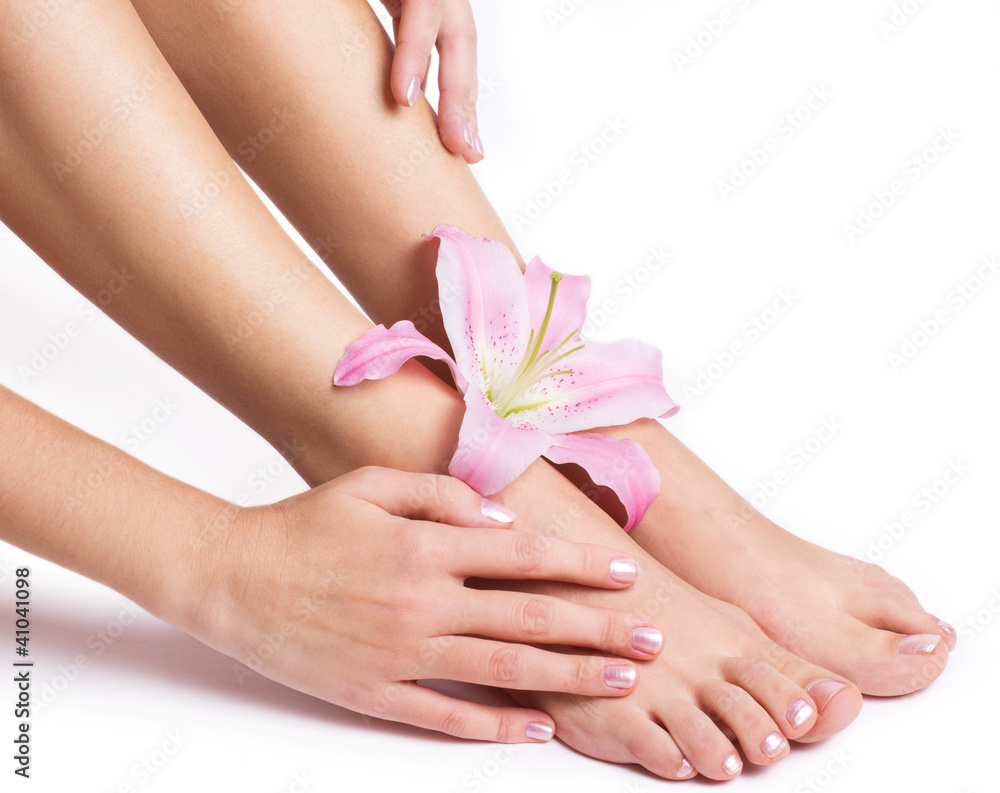 Beautiful female legs and hands with flower