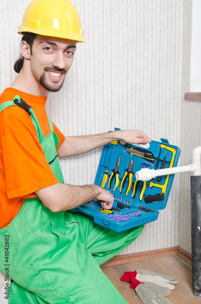 Plumber working in the bathroom Plumber working in the bathroom