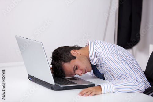 Businessman sleeping over the laptop