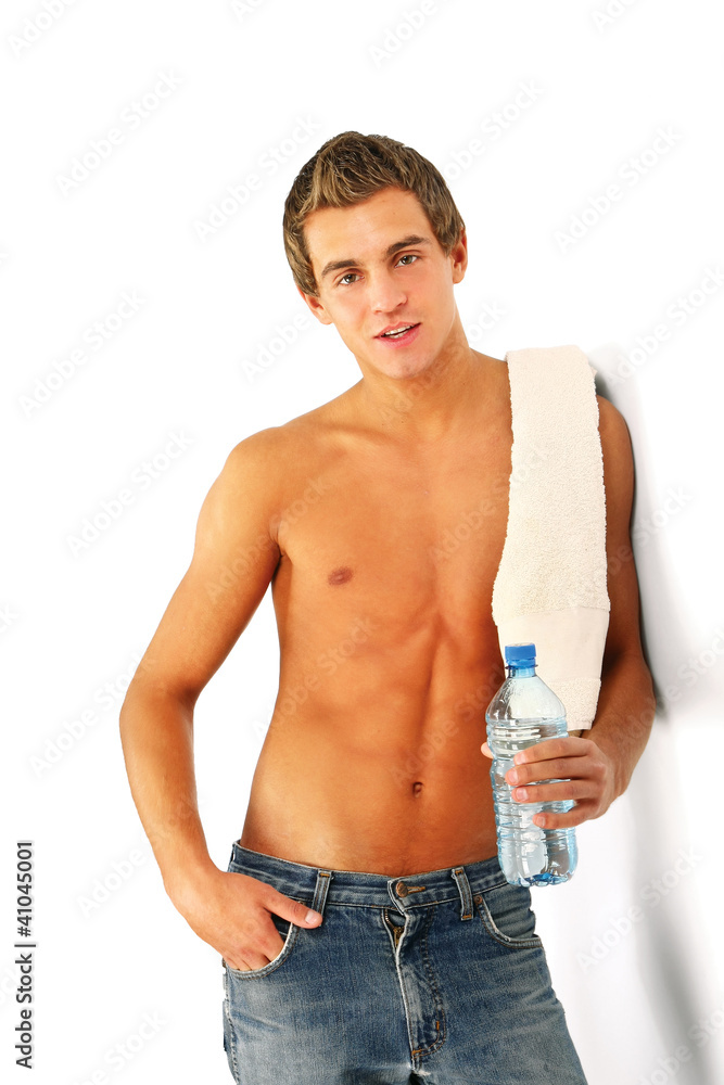 A young man with towel and water isolated on white background A young man with towel and water isolated on white background