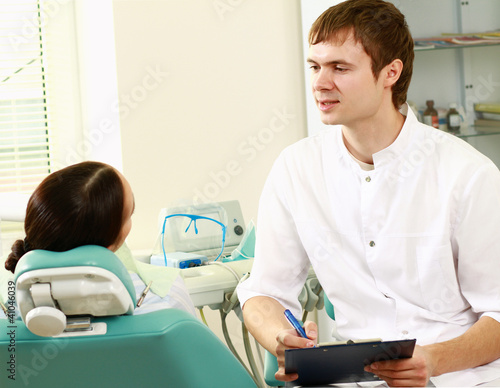 Young woman with dentist in a dental surgery. photo