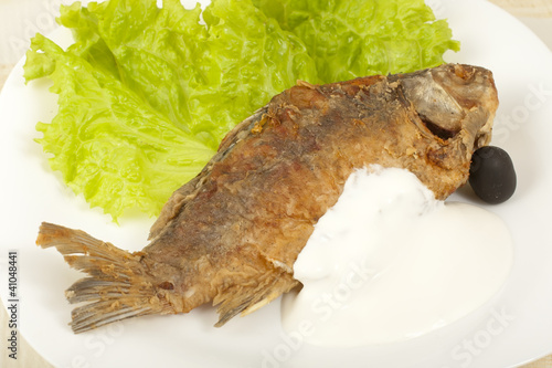 Fish fried carp with sour cream