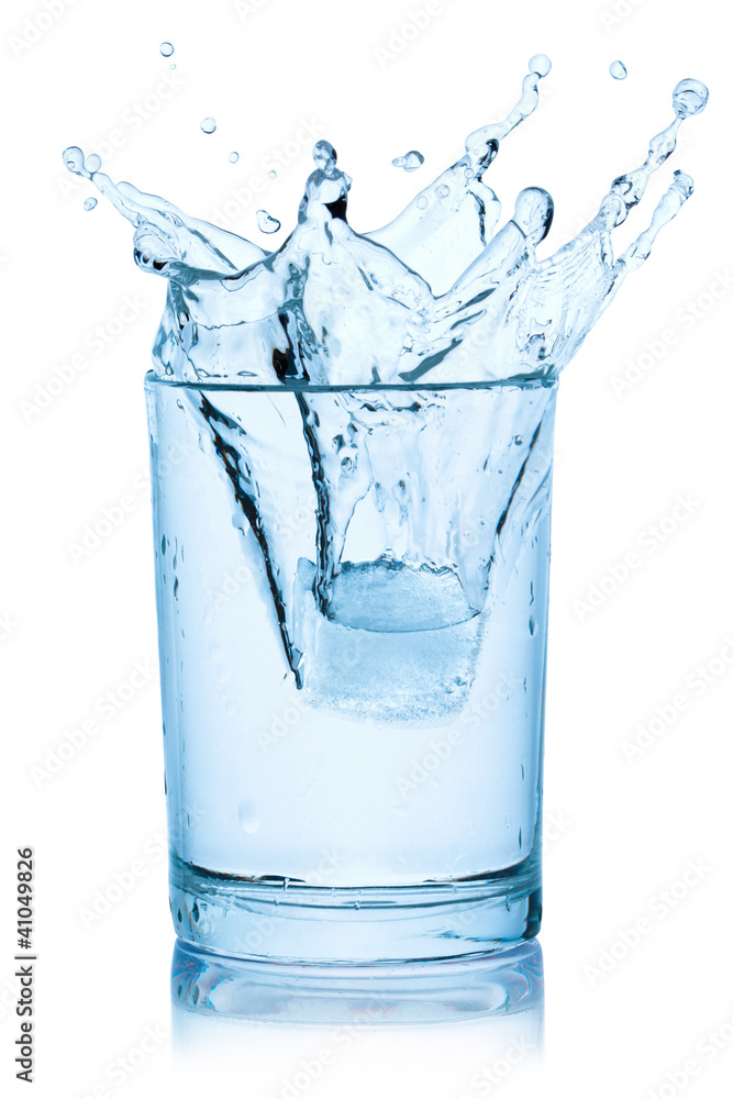 Splash from ice cube in a glass of water. Splash from ice cube in a glass of water.