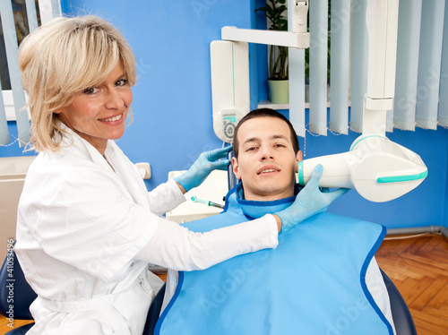 woman dentist with male patient
