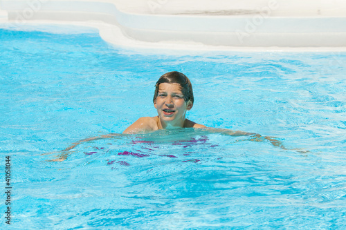 young boy swimming in the pool