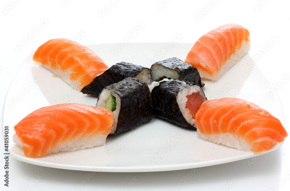 Black rolls and red sushi on plate