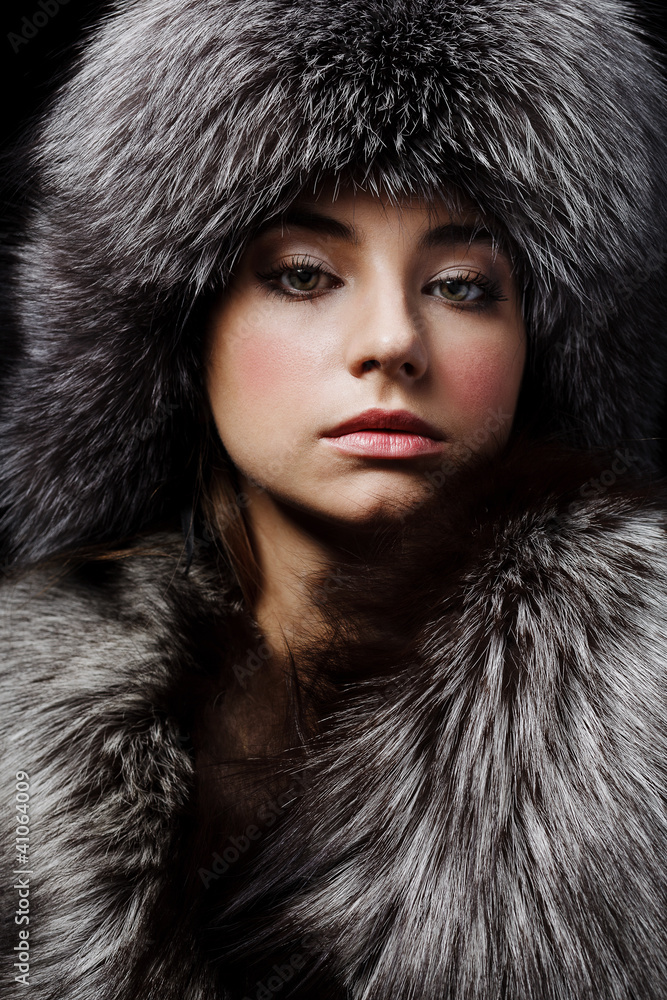 Beautiful young girl in fur clothes. Studio shot Beautiful young girl in fur clothes. Studio shot