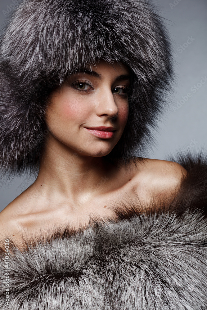 Beautiful young girl in fur clothes. Studio shot Beautiful young girl in fur clothes. Studio shot