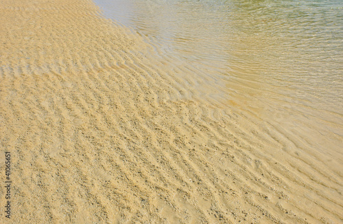 Beach wet sand ripple pattern background.