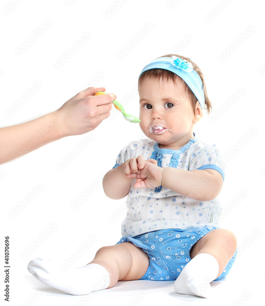 Cute baby girl eating isolated on white Cute baby girl eating isolated on white