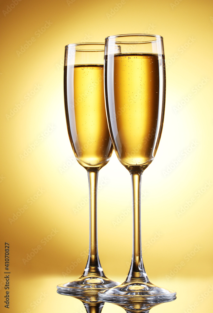 glasses of champagne on yellow background glasses of champagne on yellow background