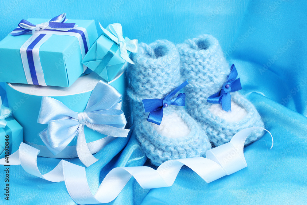 beautiful gifts and baby's bootees on blue silk beautiful gifts and baby's bootees on blue silk