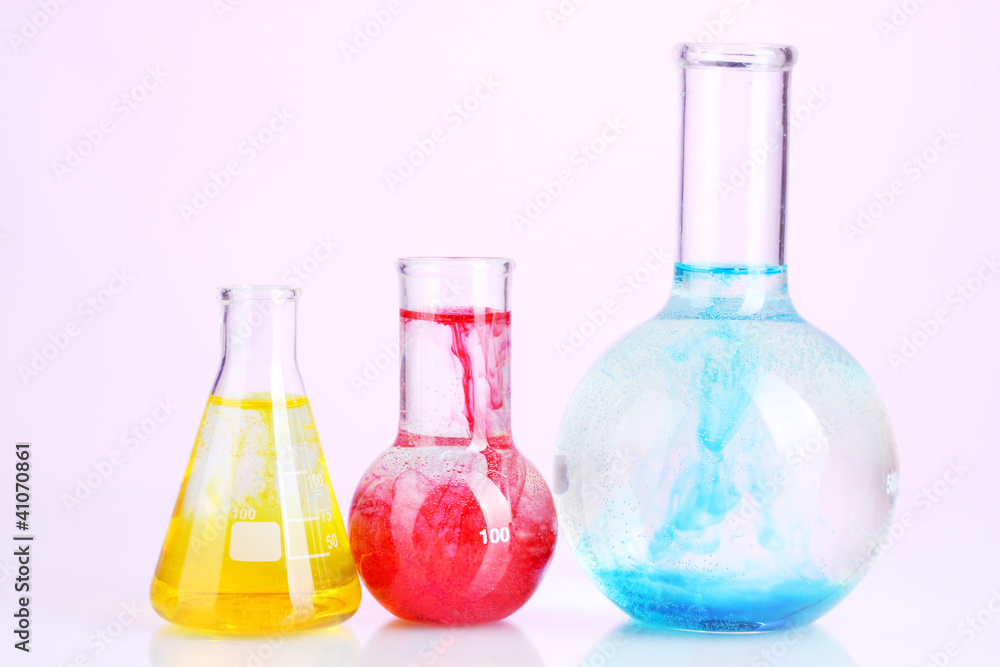 brightly ink in a flask with water on pink background brightly ink in a flask with water on pink background