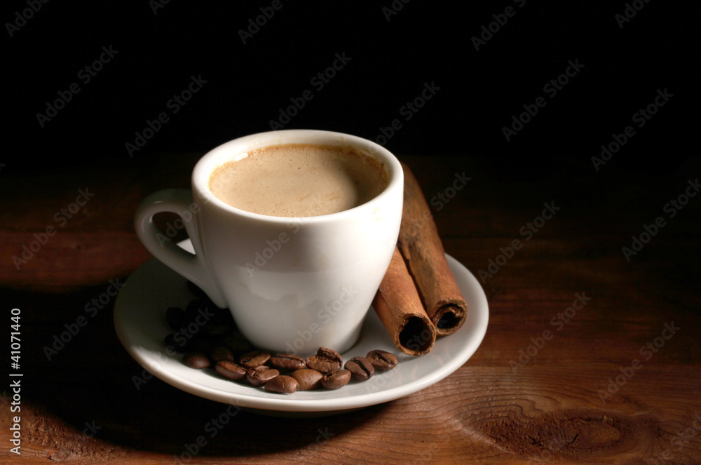 cup with coffee, cinnamon and coffee beans on wooden table cup with coffee, cinnamon and coffee beans on wooden table