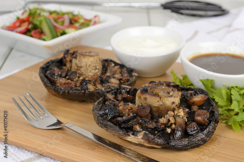 Grilled mushrooms with salad BBQ sauce and and sour cream dip photo