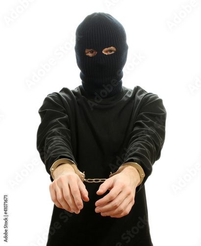 Bandit in black mask handcuffed isolated on white