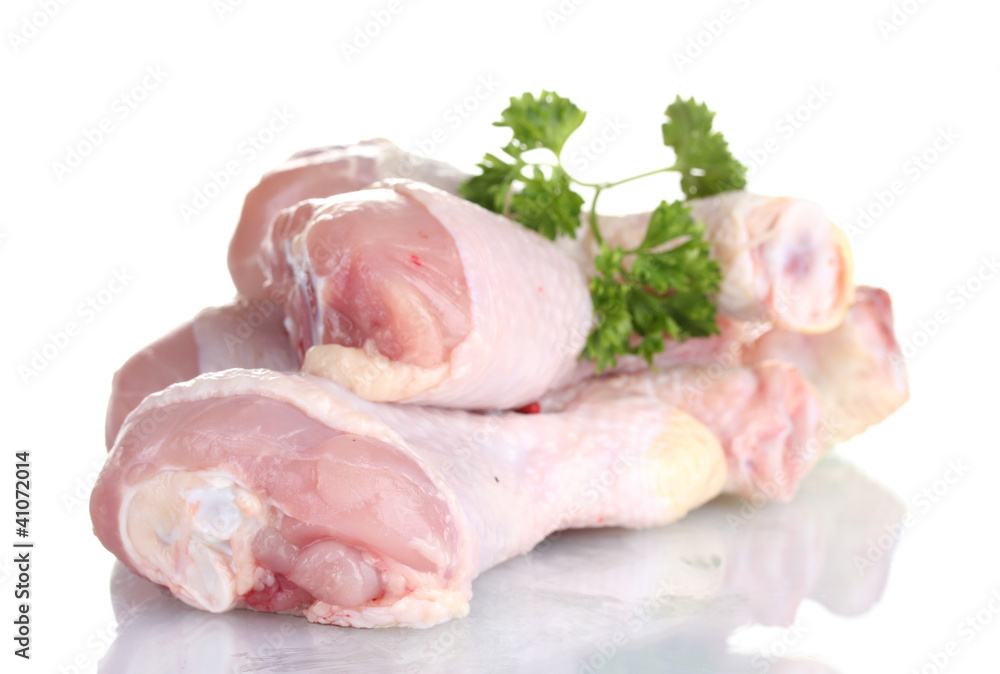 Raw Chicken Drumsticks in plate with parsley isolated on white Raw Chicken Drumsticks in plate with parsley isolated on white