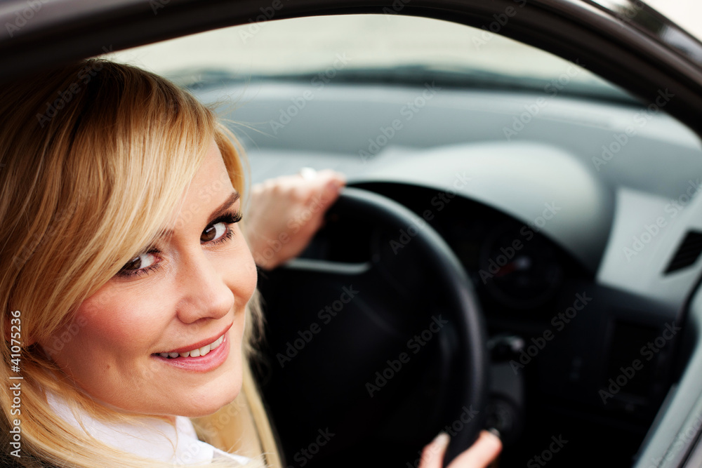 Smiling woman driver at wheel of car Smiling woman driver at wheel of car