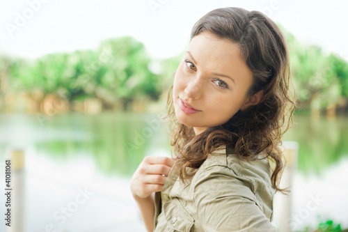 Portrait of a happy young woman posing in a park - Outdoor