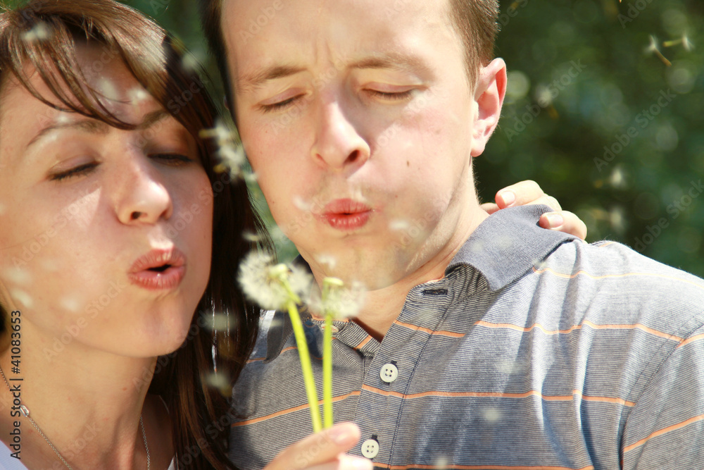 Fototapeta premium A young couple with a dandelion