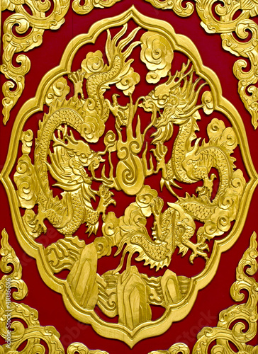 gold dragon on red background © Nattapol_Sritongcom