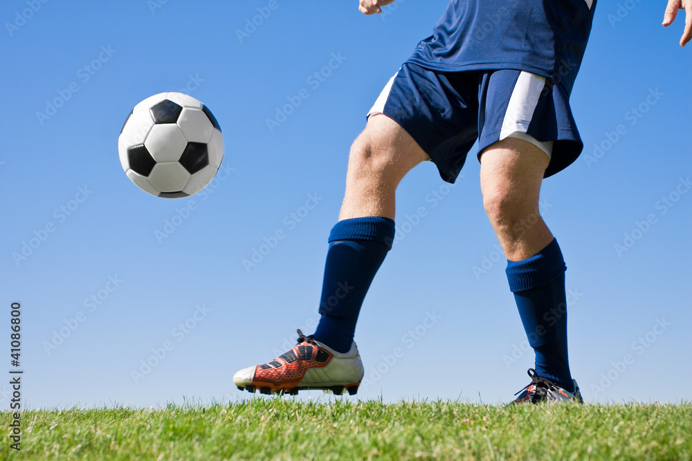 Soccer Player Kicking the ball - low angle