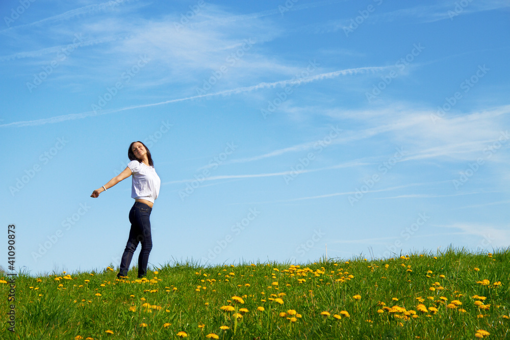smiling young girl dancing against blue sky smiling young girl dancing against blue sky