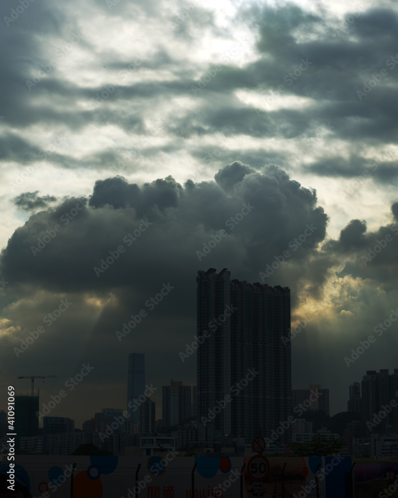The Hong Kong City skyline framed by dramatic storm clouds